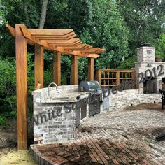 an outdoor bbq with grill and seating area