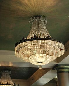 a chandelier hanging from the ceiling in a room