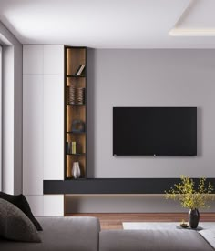 a living room with a large flat screen tv mounted on the wall above it's entertainment center