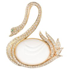 Swan diamond and emerald brooch. Bezel set oval carved Angel Skin quartz in a beautifully crafted Swan setting accented with 133 round cut diamonds and 1 round cut emerald eye. 1 oval carved angel skin quartz 133 round diamonds, H-I VS SI approx. 1.50cts 1 round green emerald, 15mm 14k yellow gold Stamped: 14k 585 20.3 grams Emerald Brooch, Swan Brooch, Gold Swan, Angel Skin, Mesh Necklace, Platinum Rose Gold, Halo Earrings, Diamond Dangle Earrings, Multi Strand Bracelet