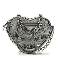 This is an authentic BALENCIAGA Metallic Agneau Arena Le Cagole Mini Heart Bag in Silver. This stylish and structured handbag is crafted of silver metallic lambskin leather. The bag features a silver link shoulder strap and a top zipper, and a front zipper pocket. The top unzips to a black fabric compact interior with card slot pockets. Silver Crossbody Shoulder Bag With Silver-tone Logo, Silver Party Bags With Silver-tone Logo Plaque, Silver Shoulder Bag With Silver-tone Hardware As Gift, Designer Silver Shoulder Bag Gift, Designer Silver Shoulder Bag As Gift, Luxury Heart-shaped Shoulder Bag, Silver Leather Shoulder Bag As Gift, Silver Leather Shoulder Bag For Gift, Silver Metallic Leather Evening Bag