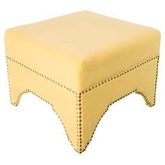 a yellow foot stool with stitching on the top and bottom, sitting in front of a white background