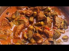 meat and vegetable stew in a pan with red sauce on the side, ready to be eaten