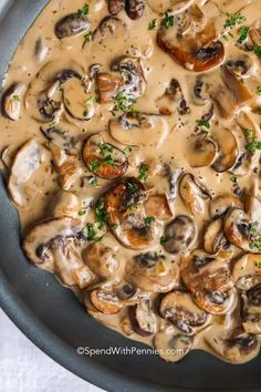 a pan filled with mushrooms covered in gravy