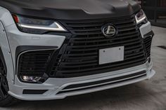 the front end of a white and black car