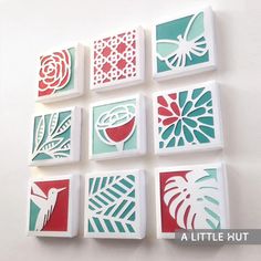 six square cut outs with different designs on the sides and one has a bird, flower, and palm tree