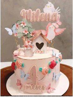 a birthday cake decorated with birds and flowers