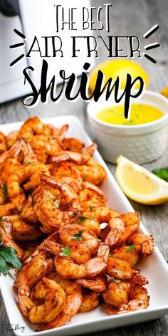 the best air fryer shrimp recipe on a plate with lemons and parsley