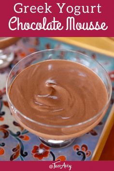 a chocolate mousse in a glass bowl with the words greek yogurt chocolate mouse