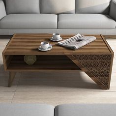 a coffee table sitting on top of a hard wood floor next to a white couch