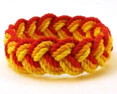 Bright colors of scarlet, orange, and golden yellow blend into a sunburst of color. Made from small batch hand dyed cotton these three part rope bracelets are handcrafted to your order. No clips buckles or buttons. Select a size that will slip on over your hand.  All sizes are inside circumference measurements: 6 1/2"  (165 mm) 7"        (178 mm)  7 1/2"  (191 mm) 8"        (203 mm) 8 1/2"  (216 mm) all are about 7/8" (23 mm) wide Advice on how to measure your hand and estimate your size here:  (please copy-and-paste this link into your browser) https://whatknotnow.blogspot.com/2009/10/figuring-fit-how-to-pick-size-thats.html Will shrink slightly when wet. Makes a great gift! Add your personal greeting at check-out.  Festive red fabric gift bag available for a small extra charge. Sailor Knot Bracelet, Sailor Bracelet, Paracord Braids, Rope Bracelets, Surfer Bracelets, Rope Jewelry, Red Rope, Jaune Orange, Red Bracelets