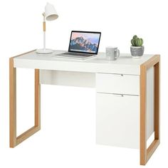 a white desk with a laptop on it and a potted plant next to it