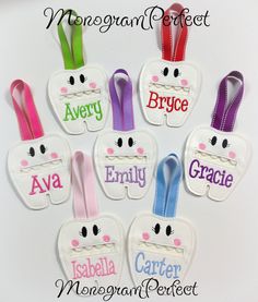 a group of paper cut outs with name tags attached to them, all decorated in different colors