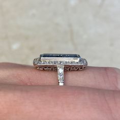 a woman's hand holding an engagement ring with a diamond band on top of it