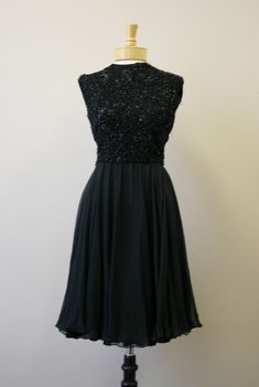 "Description: 1960s black silk beaded cocktail dress. Sleeveless. The bodice is beaded and the skirt is a floaty silk chiffon. Back zipper and hook and eye closure. There is a band inside at the waist with a hook and eye closure to help support the beaded top. Lined. Condition: In good condition, with no holes or stains. The bodice has a few small areas of missing beads. Designer: Royal Lynne Stated Size: n/a Measurements: Armpit to armpit: 17.5\" Bodice length: 15.75\" Overall length: 38\" Wais Vintage Black Sleeveless Evening Dress, Sleeveless Beaded Cocktail Evening Dress, Beaded Sleeveless Cocktail Evening Dress, Sleeveless Beaded Cocktail Dress, Beaded Sleeveless Cocktail Dress, Black Embellished Chiffon Evening Dress, Beaded Cocktail Dress, Beaded Top, Dress Sleeveless