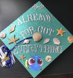 a green graduation cap with sea shells and starfish on it that says already for got everything