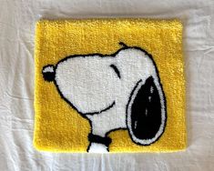 a yellow towel with a snoopy dog on it's front and back side