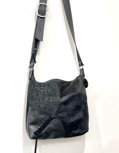 Boheme Multi Leather Crossbody Bag Handmade in Australia **BLACK Embossed Leather hobo shown with gunmetal hardware *  Leather lacing on bag and strap *  Features premium embossed leathers on the front of the bag. Plain black leather on the back. *  Choose your lining and hardware finish *  3 inside leather edged pockets, riveted *  YKK metal zipper closure (if you choose gunmetal hardware, the zipper will be black coil handbag zipper) *  NEW - I have added an outside zipper pocket on the back. *  Size: 35cm wide x 31cm (13.5 inch x 12 inch). Depth at bottom: 7cm (2.8 inch) *  Strong adjustable leather strap (SHOULDER to CROSSBODY) 97cm - 128cm long (38 - 50.5"), 3.5cm wide (1.4" wide).  Has clean suede underside strap for non-slip. *  Your new everyday bag.  Fitting everything you need. Clean Suede, How To Clean Suede, Leather Lacing, Gunmetal Hardware, Teal Leather, Latest Bags, Hobo Style, Sling Bags, Leather Pieces