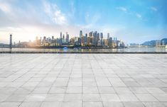 an empty concrete floor with the city skyline in the background