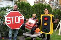 two adults and a child are dressed up as stop signs