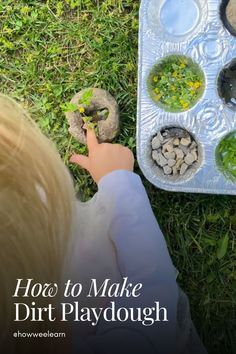 a child is playing with dirt playdough in the grass