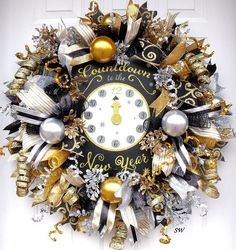 a clock decorated with gold, silver and black ornaments is hanging on the front door