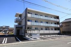 an apartment building with balconies on the second floor