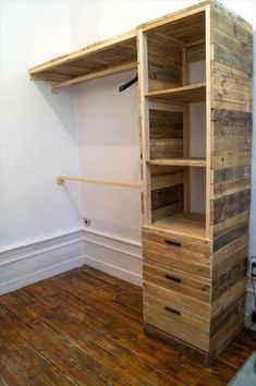 an empty room with wooden shelves and drawers