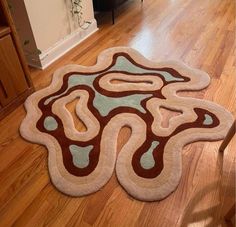 a living room with hardwood floors and a rug on the floor that looks like an animal