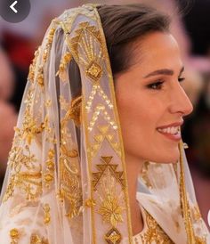 a woman wearing a veil and gold jewelry