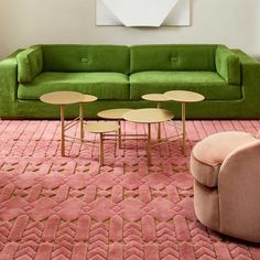 a living room with pink carpet and green couches