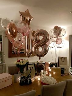 a table topped with lots of balloons in the shape of numbers