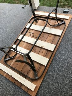 a chair sitting on top of a wooden floor next to a metal pole and some wires