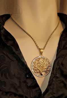 Stainless Steel Necklace: Celebrate the beauty of nature with this exquisite Gold Tree of Life Pendant Necklace. This stunning piece features a detailed tree of life design, adorned with sparkling crystal accents, making it a perfect symbol of growth, strength, and harmony. Crafted from high-quality stainless steel with a gold finish, this necklace is both durable and stylish. Pendant Material: High-quality stainless steel with gold finish Chain Material: Stainless steel chain with gold finish S Nature-inspired Tree Of Life Round Jewelry, Gold Tree Of Life Nature-inspired Jewelry, Tree Symbolism, Gold Tree Of Life, Necklace Tree, Tree Of Life Jewelry, Gold Tree, Tree Necklace, Meaningful Jewelry