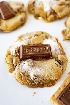 chocolate chip cookies and marshmallows are on a white surface with the word hershey's