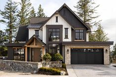 a large house with two garages in front of it