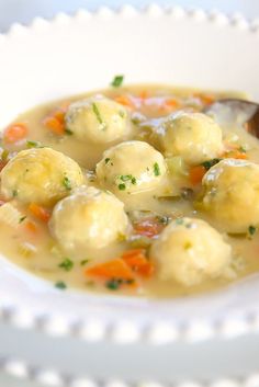 a white bowl filled with dumplings and carrots