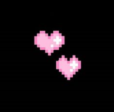 two pink hearts are in the dark