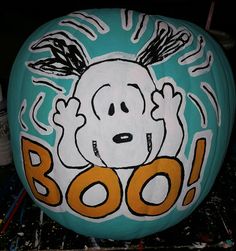 a painted pumpkin with a cartoon dog on it