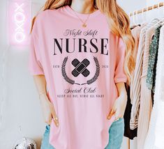 Custom Year Night Shift Nurse Social Club t-shirt.  These tees are Comfort Colors and are made to last using premium ringspun cotton, this creates an vintage-soft shirt. The soft-washed, garment-dyed fabric brings extra coziness to your wardrobe while the relaxed fit makes it an excellent daily choice. ✦ 100% Ringspun Cotton ✦ Relaxed fit ✦ Medium fabric ✦ Sewn-in twill label ✦ Eco-friendly, Ethically Made & Sweatshop Free ✦ Printed to order with non-toxic ink ✦ Durable and Long-lasting ✦ Shirts Graphic Print Crew Neck Sleepwear For Bedtime, Graphic Print Crew Neck Sleepwear, Pink Graphic Print Crew Neck Sleepwear, Crew Neck Graphic Print Sleepwear, Pink Crew Neck Sleepwear With Graphic Print, Pink Cotton Sleep T-shirt, Graphic Print Short Sleeve Bedtime Top, Pink Crew Neck Top For Bedtime, Bedtime Crew Neck Top With Graphic Print