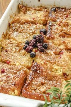 a casserole dish with berries and powdered sugar