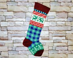 a christmas stocking hanging on a brick wall