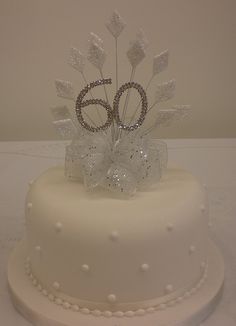 a white cake with silver decorations on top