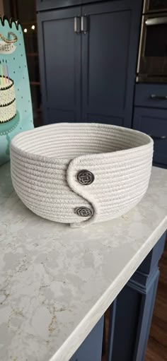 a large white bowl sitting on top of a counter next to a blue oven door