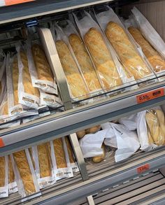 breads in plastic bags are on display at a grocery store's refrigeration