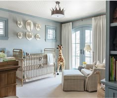 a baby's room with a giraffe statue in the corner