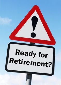 a red and white sign that says ready for retirement on it's side against a blue sky with wispy clouds