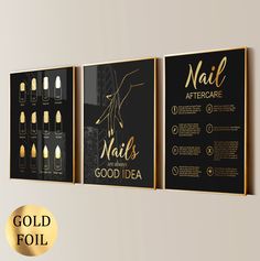 three black and gold posters hanging on the wall next to each other, one with nails