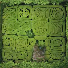 an aerial view of a maze in the grass