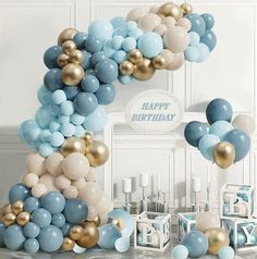 a number one made out of balloons in blue, gold and white